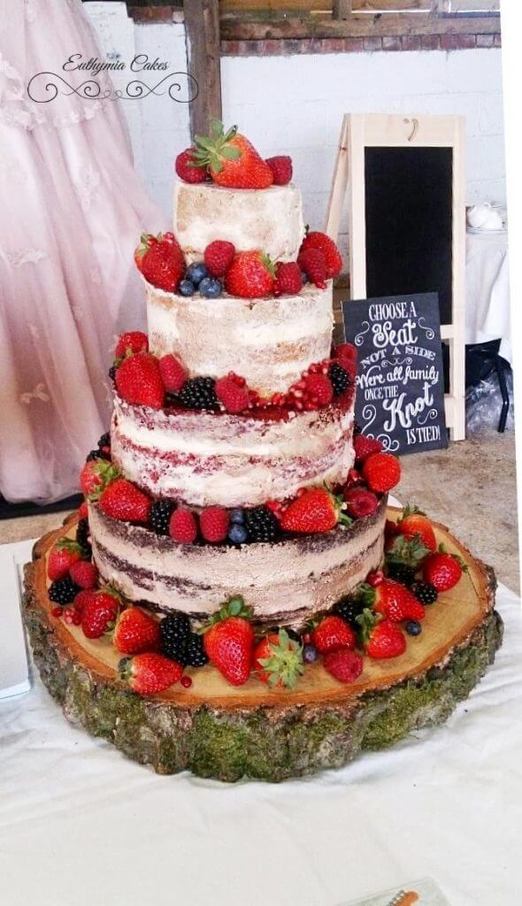 Bespoke Wedding Cakes 4 tier rustic wedding cake with fresh berries and gold paint Furtho Manor Farm